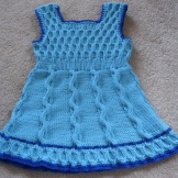 Knitted dress for a girl with A-silhouette knitting needles