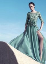 Evening dress on the floor with guipure sleeves green