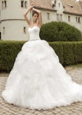 Magnificent white wedding dress with a multi-layered skirt
