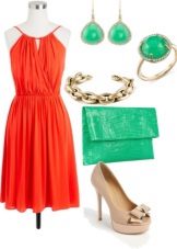 Coral-colored dress in combination with green accessories