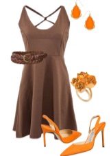 Orange sandals under a brown dress