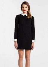 Short black dress with a straight silhouette with white cuffs and a collar
