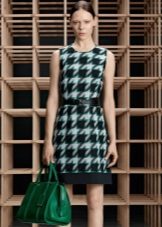 Dress with black and green crows feet on a white background