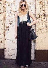 Long black half skirt in combination with denim vest
