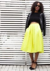 Bright skirt below the knee in combination with a dark top