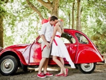 Wedding dress with a red belt and a red car