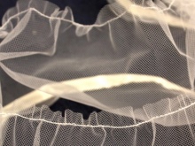 A line on the edge of the tulle to tighten the assembly