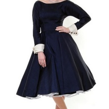 Fluffy blue dress with long sleeves and white cuffs on them in the style of the 50s