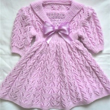 Knitted dress for the girl with knitting sleeves