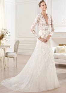 Wedding dress with a long openwork sleeve