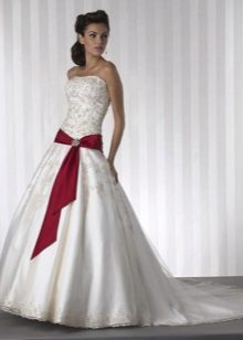 Wedding dress with a red ribbon on the hips