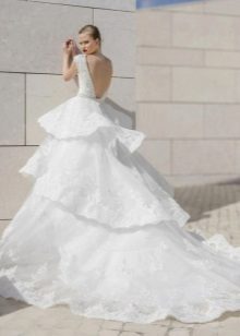 Wedding magnificent dress with a multi-tiered skirt and train