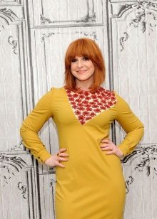 Red-haired girl in a mustard dress