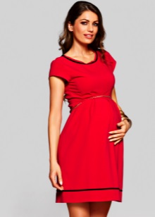 Red maternity dress with black trim on the neck and the bottom of the skirt