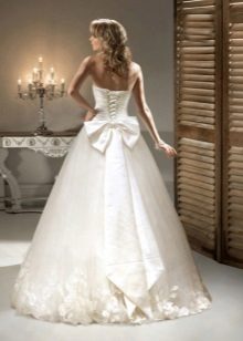 Wedding dress with bow and flowers in tone