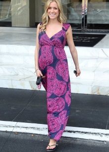 Long summer dress on the floor for pregnant women and shoes for her