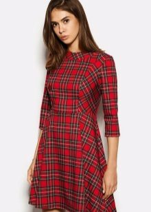 Red dress in a cage A-shaped silhouette with a sleeve in three quarters