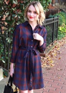 A blue classic dress with a checkered shirt and a black bag.