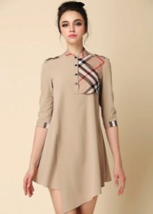 Beige dress with an asymmetrical bottom with a checkered insert on the chest