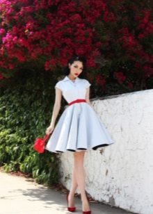 White cocktail dress in the style of the 50s with a red belt