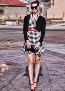 Dress crows feet in combination with red accessories and a black cardigan