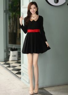 Black short dress with a skirt and a sun red belt