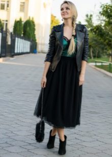 Long layered black skirt in combination with a jacket