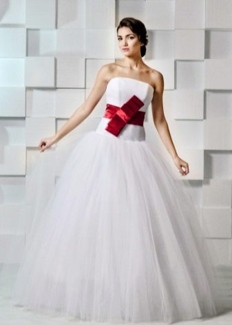 Wedding dress with a red bow tied in the middle
