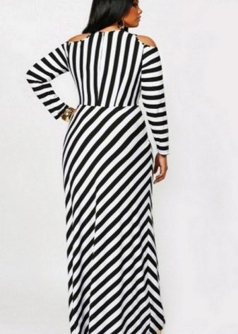 Floor-length striped black and white dress of a simple cut for a full woman (girl)