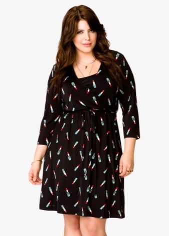 Black knitted dress with a not large pattern for a full girl