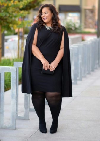 Large black office dress in a combination with a raincoat and black tights