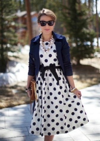 White dress in a black polka dot with a black belt