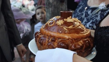 Who takes out and holds the loaf at the wedding?