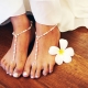 Choosing a white pedicure design with rhinestones