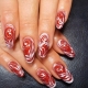 Red manicure with a pattern: features and design examples