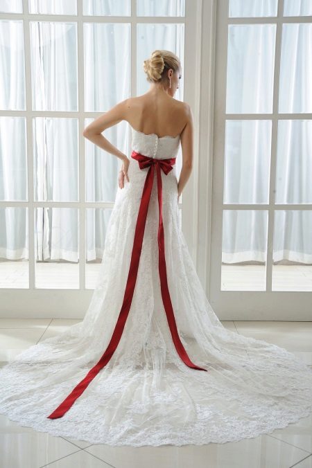 Wedding dress with a red bow at the back