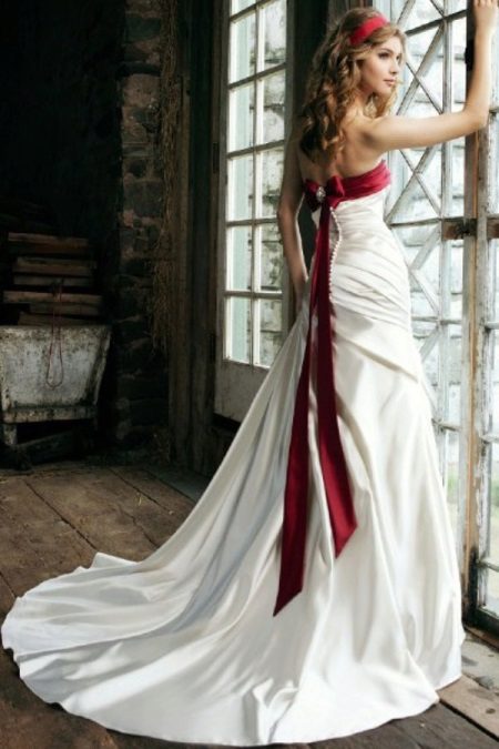 Wedding dress with red ribbon on the bodice