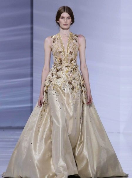 Dress beige evening with a deep neckline