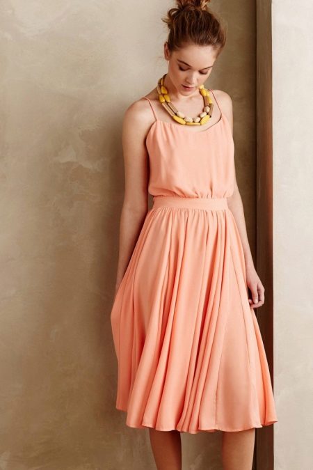 peach dress with a pleated skirt